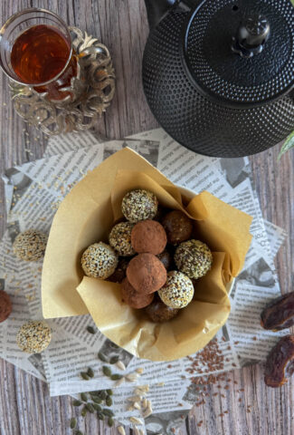 energy balls in a small bowl served with black tea